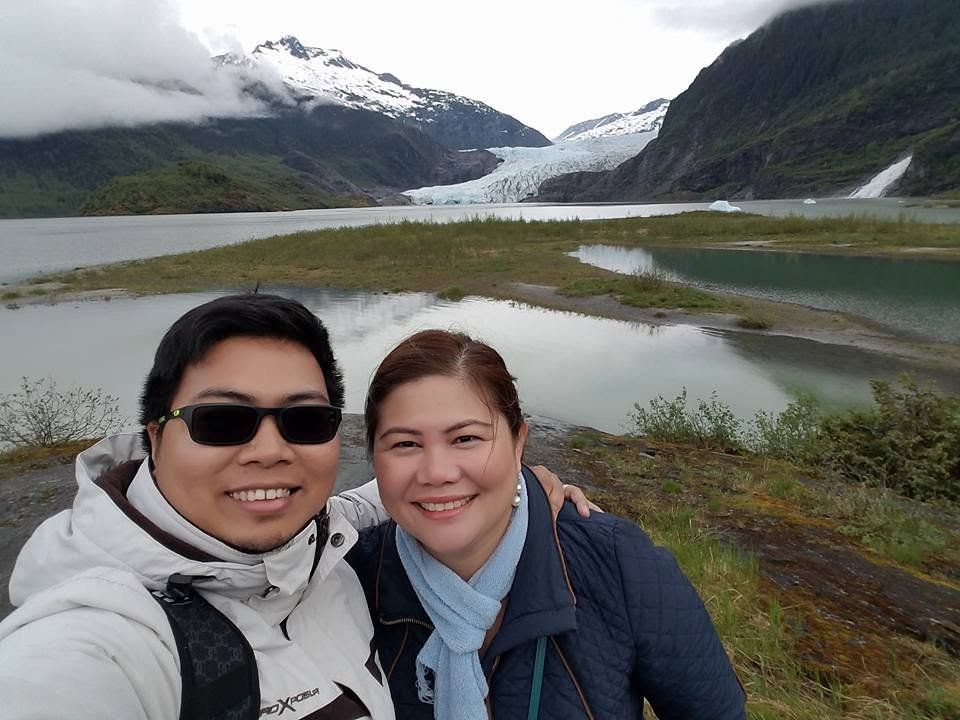 Rochelle and Nathaniel together in front of a glacier in Alaska